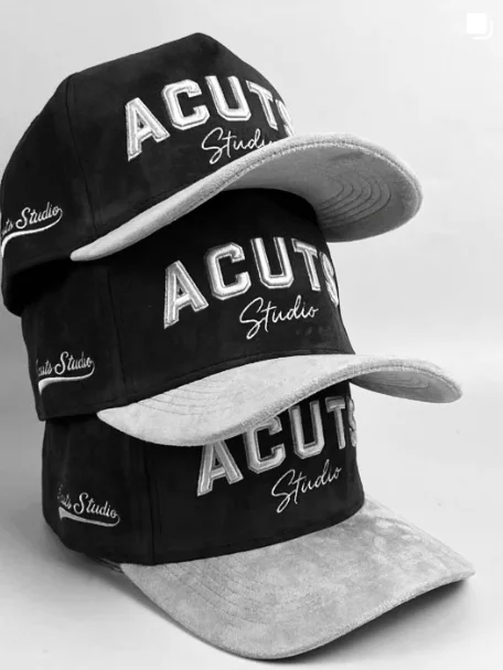 Stack of black and gray ACUTS Studio caps